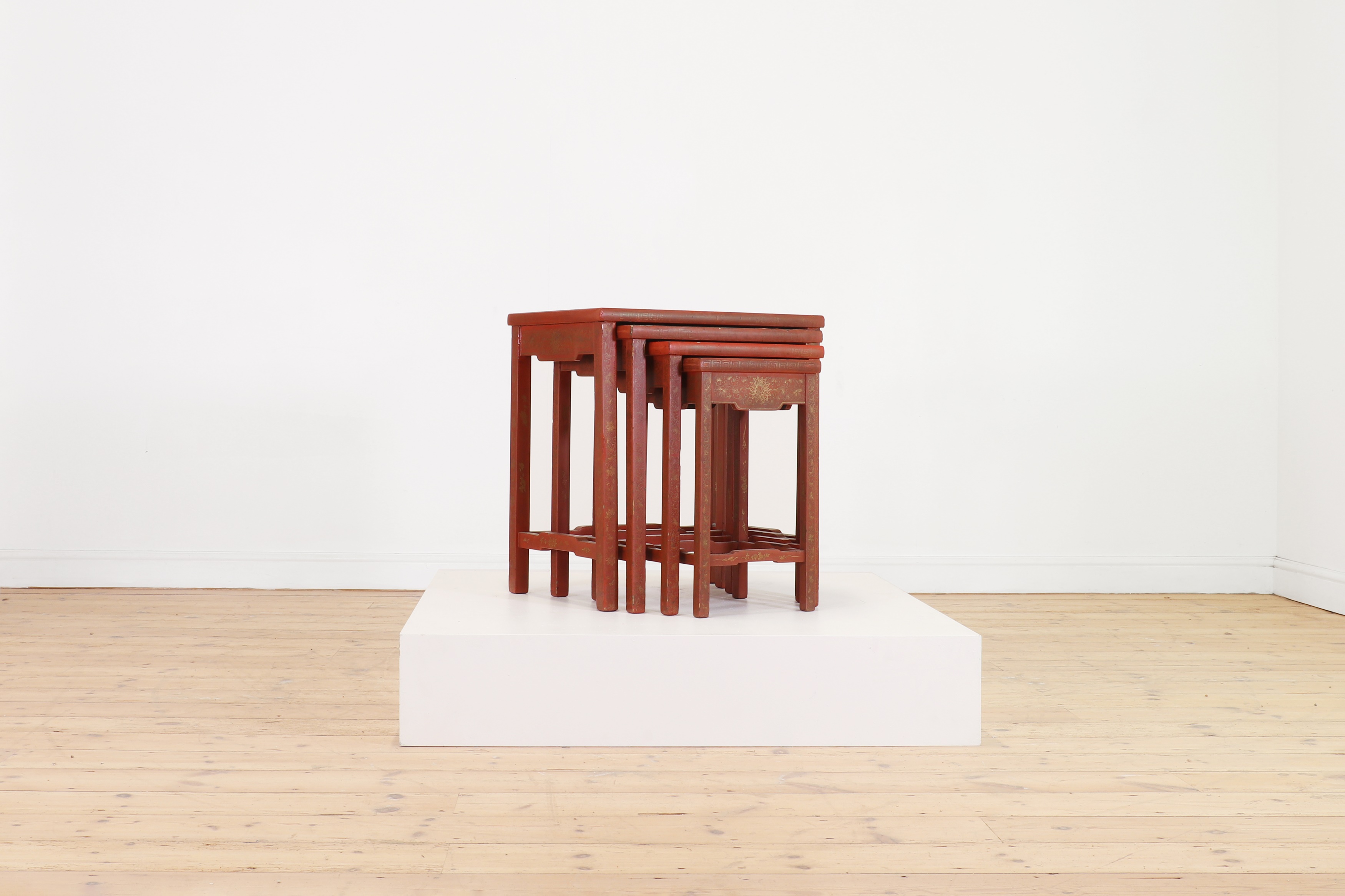 A quartetto nest of red-lacquered tables