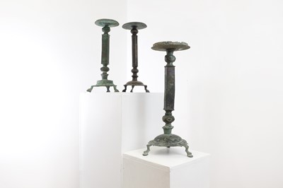 Lot 209 - A group of three Islamic bronze candlesticks