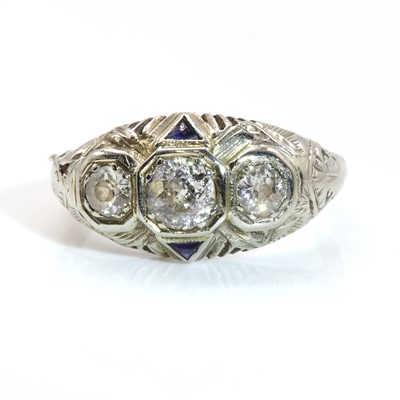 Lot 63 - An American Art Deco three stone diamond and synthetic sapphire ring