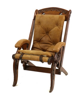 Lot 395 - An oak campaign armchair