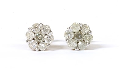 Lot 91 - A pair of gold diamond daisy cluster earrings