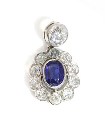 Lot 297 - A sapphire and diamond oval cluster pendant