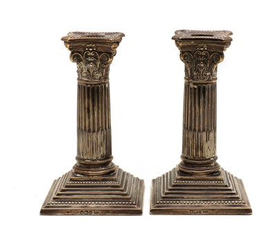 Lot 34 - A pair of Edwardian silver candlesticks