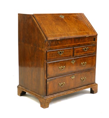 Lot 360 - A Georgian walnut and feather banded bureau