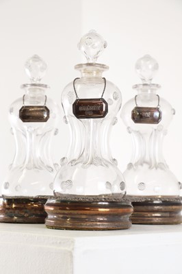 Lot 384 - A set of three glass scrooge decanters