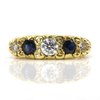 Lot 295 - An 18ct gold five stone diamond and sapphire carved head style ring