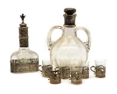 Lot 38 - A Dutch silver mounted decanter and six silver cup holders