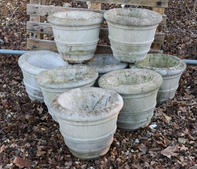 Lot 485 - A set of eight small reconstituted stone garden urns