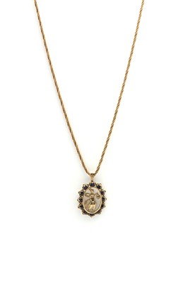 Lot 142 - A 9ct gold sapphire pendant