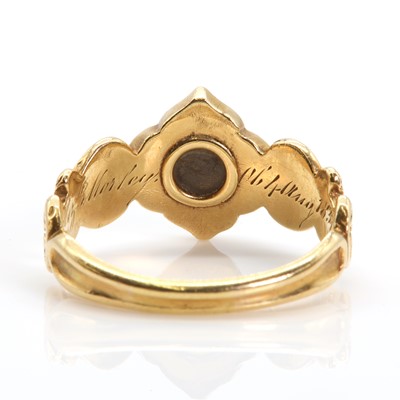 Lot 15 - An 18ct gold garnet memorial ring