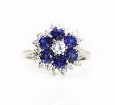 Lot 298 - A diamond and sapphire cluster ring