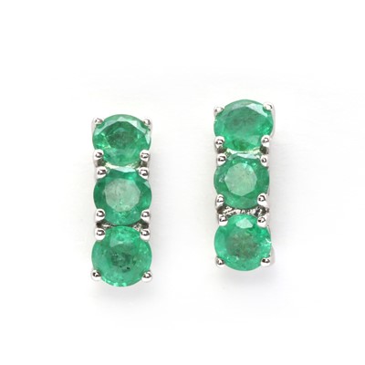 Lot 123 - A pair of 9ct white gold three stone emerald earrings