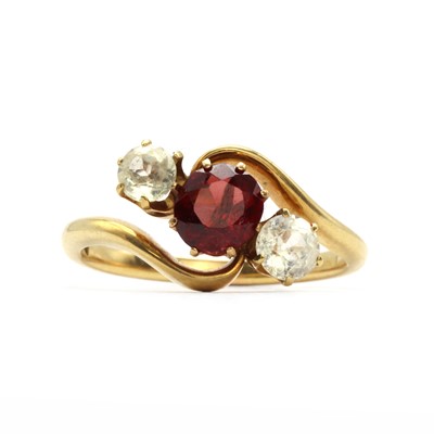 Lot 30 - An Edwardian three stone garnet and white sapphire crossover ring