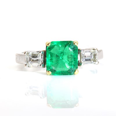 Lot 251 - An 18ct yellow and white gold three stone emerald and diamond ring