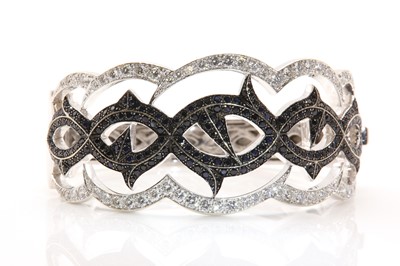 Lot 434 - An 18ct white gold sapphire and diamond hinged bangle, by Stephen Webster