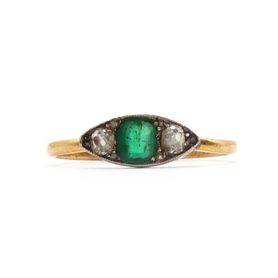 Lot 121 - A three stone Emerald and diamond boat shaped ring