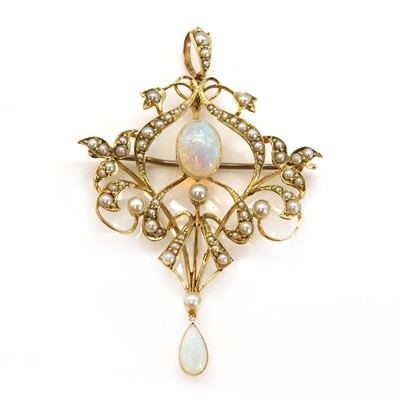 Lot 103 - An Edwardian opal and split pearl Art Nouveau scrolling brooch/pendant