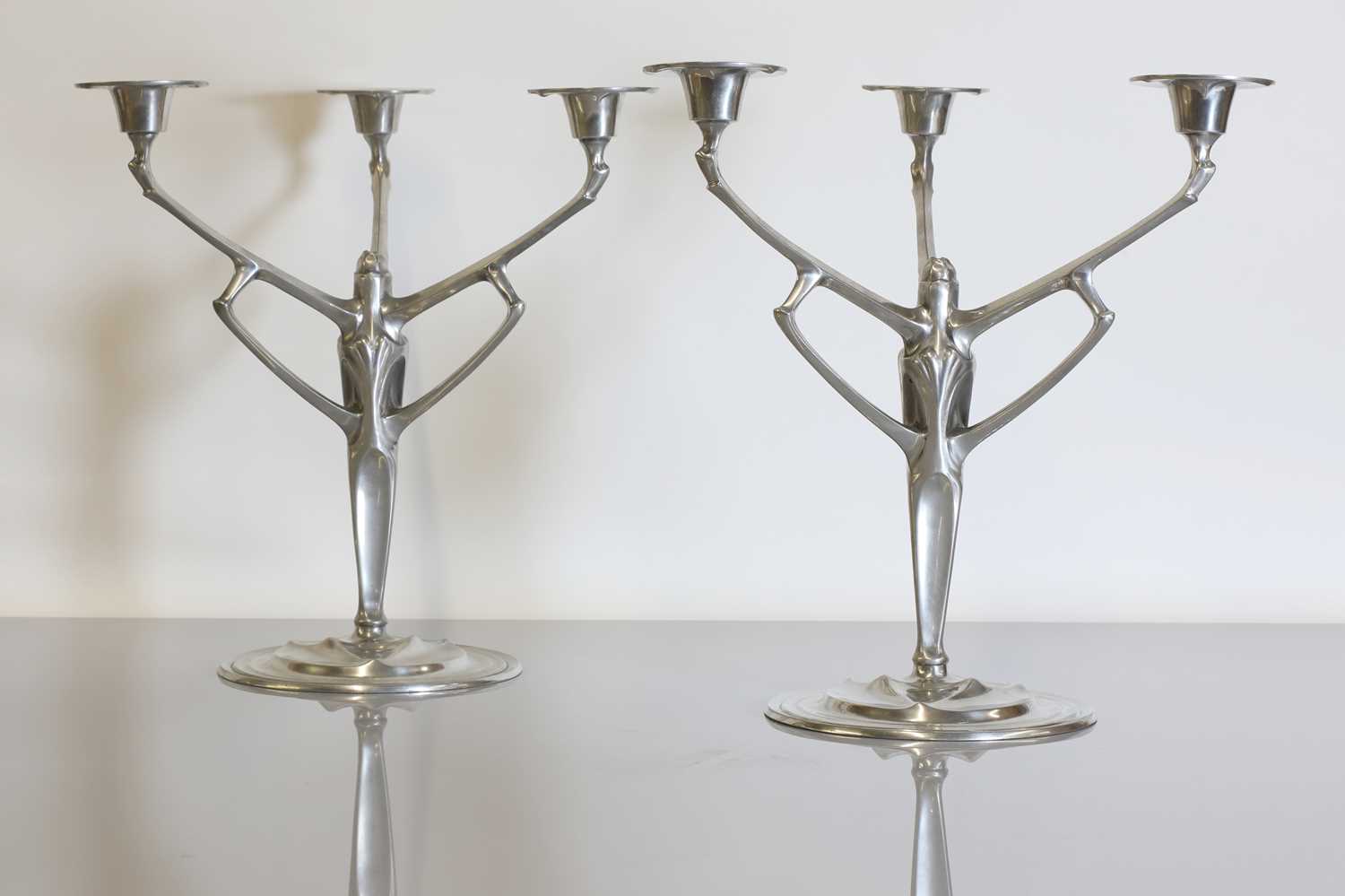 Lot 140 - A pair of pewter candelabra