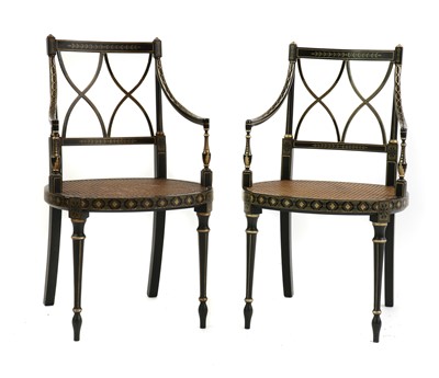 Lot 305 - A pair of Regency-style ebonised elbow chairs