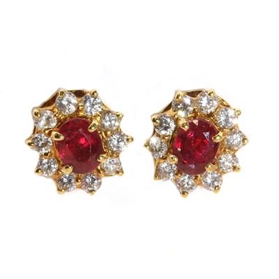 Lot 267 - A pair of Continental ruby and diamond oval cluster earrings