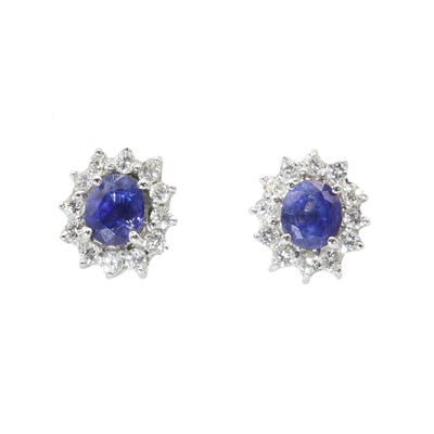 Lot 151 - A pair of Continental sapphire and diamond oval cluster earrings