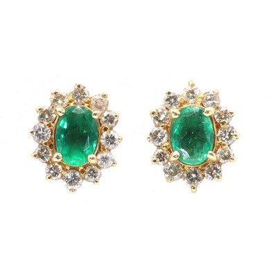 Lot 110 - A pair of Continental emerald and diamond oval cluster earrings