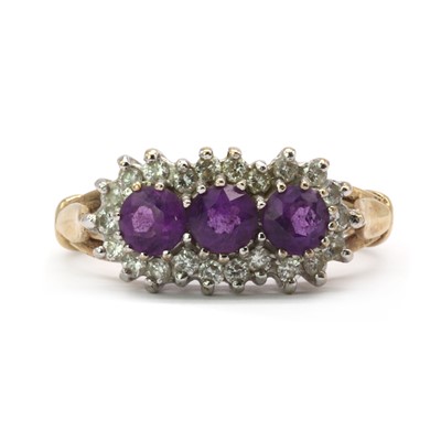 Lot 128 - A 9ct gold amethyst and diamond three stone cluster ring