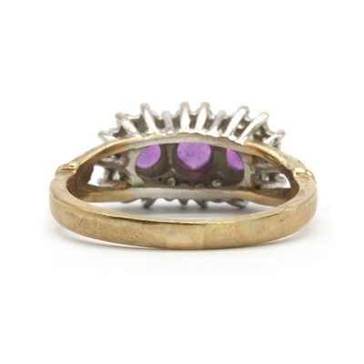 Lot 128 - A 9ct gold amethyst and diamond three stone cluster ring