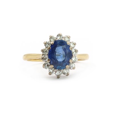 Lot 102 - An 18ct gold sapphire and diamond oval cluster ring