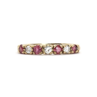 Lot 62 - A 9ct gold ruby and diamond half eternity ring