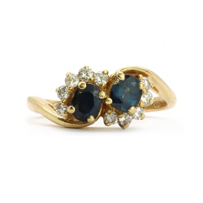 Lot 99 - An 18ct gold two stone sapphire and diamond cluster ring