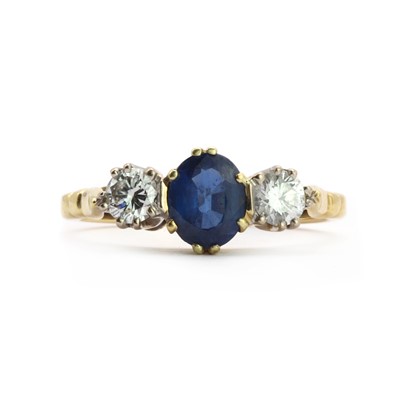 Lot 83 - An 18ct gold three stone sapphire and diamond ring