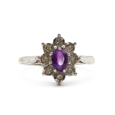 Lot 134 - A 9ct white gold amethyst and diamond cluster ring