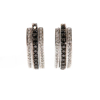 Lot 426 - A pair of 18ct white gold three row black and colourless diamond cuff style earrings