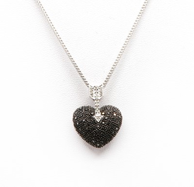 Lot 425 - An 18ct white gold black and colourless diamond heart and arrow pendant and chain, c.2003