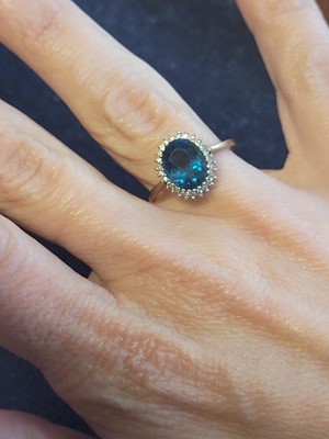 Lot 119 - A 9ct gold topaz and diamond cluster ring