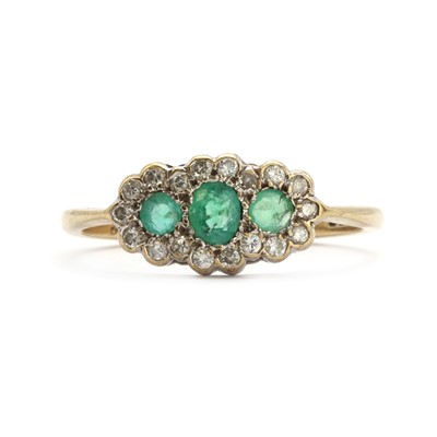 Lot 74 - A 9ct gold emerald and diamond cluster ring