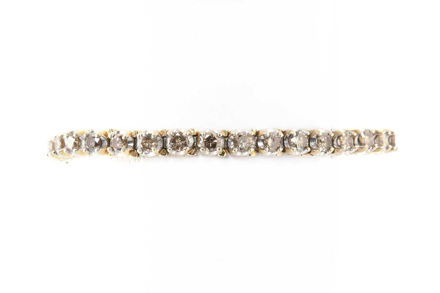 Lot 201 - A diamond set line bracelet,
