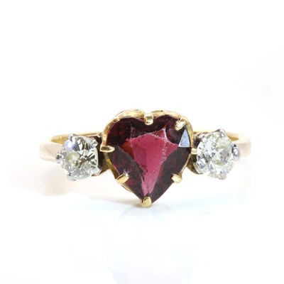 Lot 390 - A three stone garnet and diamond ring