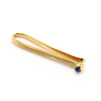 Lot 277 - A gold sapphire tie slide