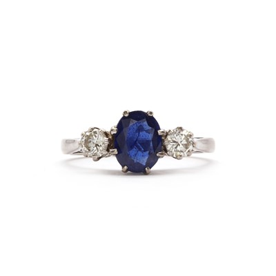 Lot 138 - An 18ct white gold three stone sapphire and diamond ring