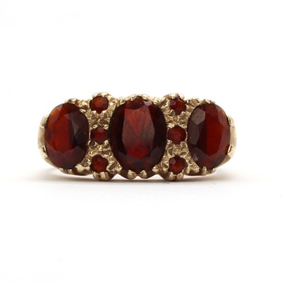 Lot 110 - A 9ct gold three stone garnet ring