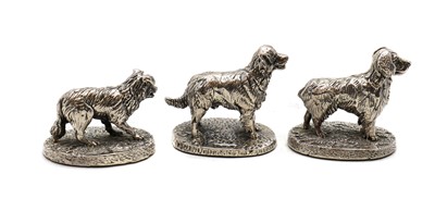 Lot 69 - A set of three silver figures of dogs