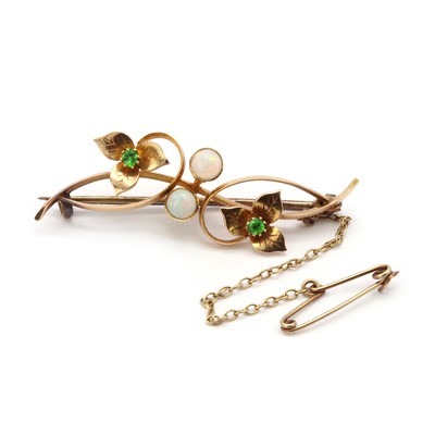 Lot 47 - An Art Nouveau gold opal and demantoid garnet bar brooch, retailed by Liberty