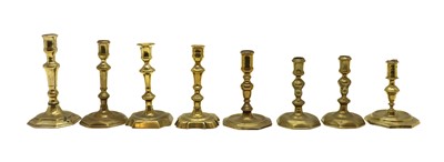 Lot 341 - Eight Georgian brass candlesticks