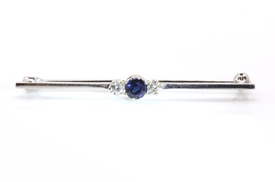 Lot 303 - An 18ct white gold three stone sapphire and diamond bar brooch, by Cropp & Farr