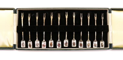 Lot 18 - A cased set of twelve silver and enamelled cocktail sticks