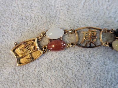 Lot 146 - A vari-colour jade panel bracelet