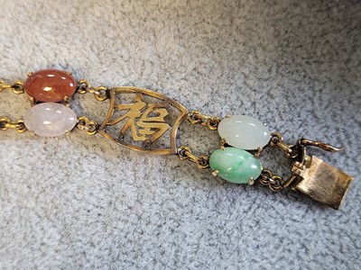 Lot 146 - A vari-colour jade panel bracelet