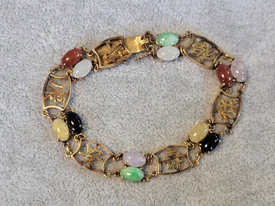 Lot 146 - A vari-colour jade panel bracelet